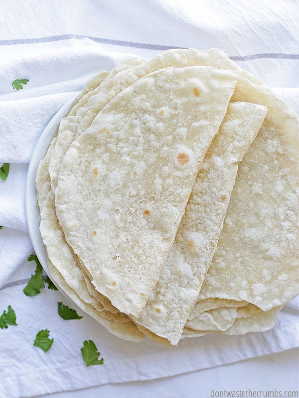 Light brown toasted spots dot folded tortillas.