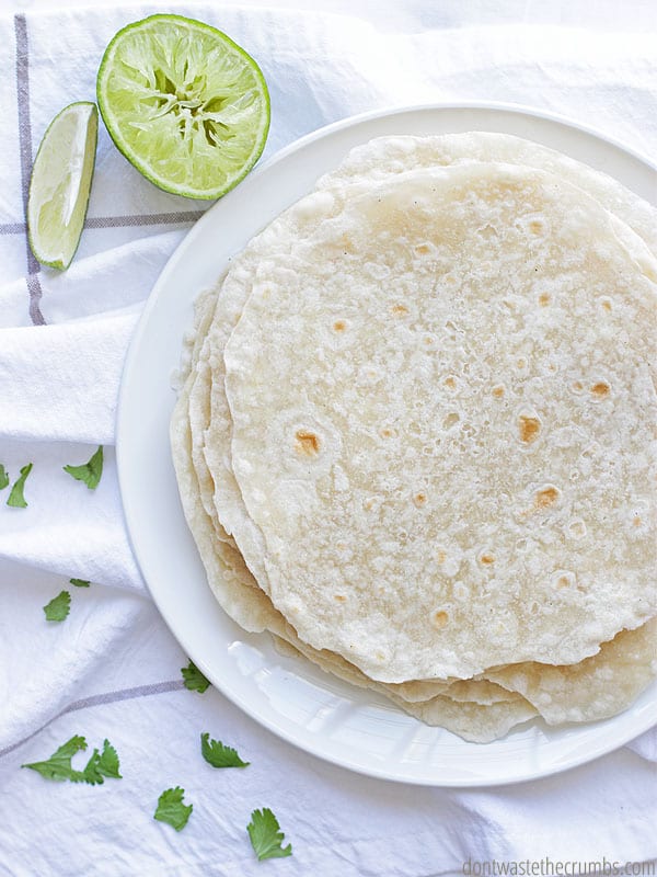 Tortillas are stacked on a plate.