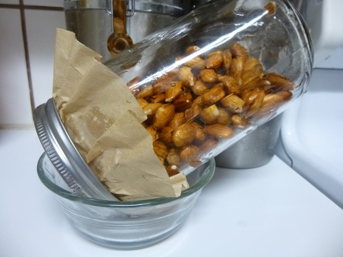 All you need to create sprouted almonds is 2 cups of raw almonds, filtered water, a quart jar with lid, a coffee filter, and a small bowl.