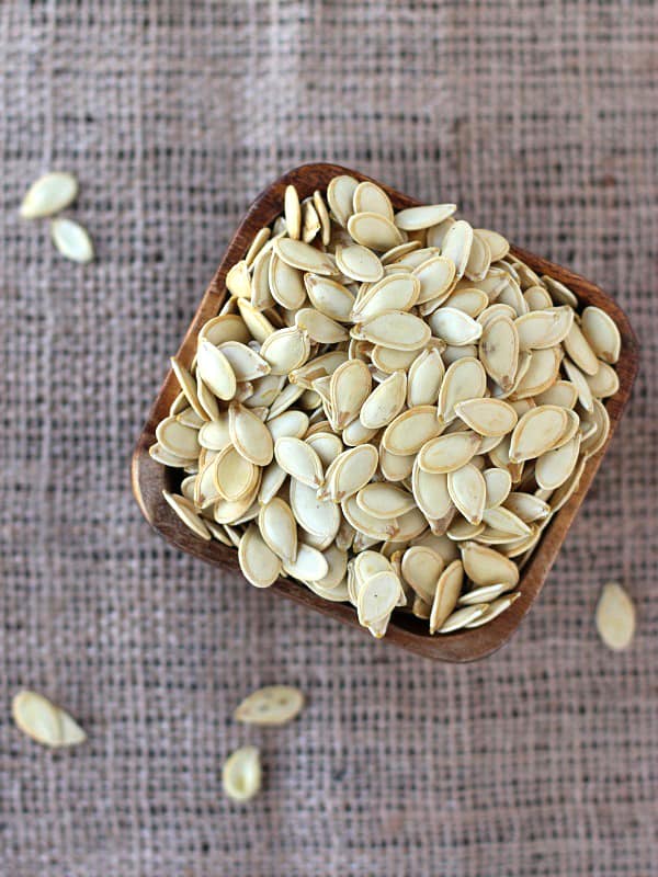 Seasoning roasted pumpkin seeds is easy and you can use spices you already have, like garlic, or cinnamon.