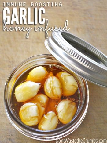 Jar of honey infused garlic cloves with text overlay, "Immune Boosting Garlic Honey Infused".