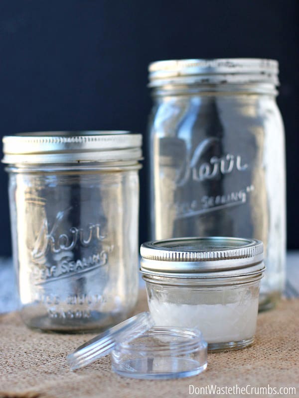 Three clear, clean glass jars and one small clear container. Using jars for storage is a great way to save money.