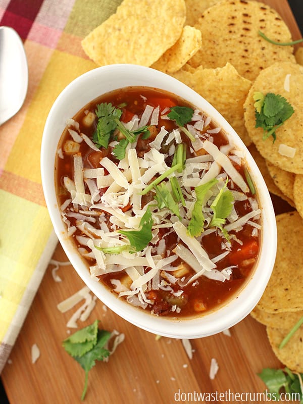 This bowl of taco soup is easy to make and within the $50 budget for our one week meal plan! It is  topped with shredded cheese and cilantro is sprinkled on top. Chips are paired on the side for some added crunch. Yum!