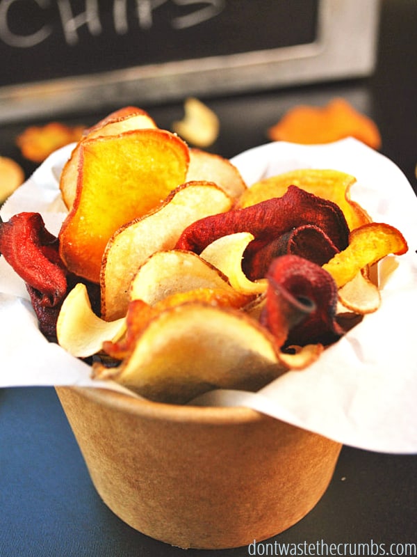 Homemade root vegetable chips in a cup.