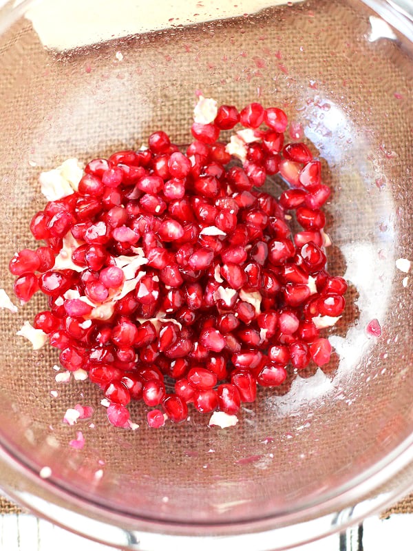 When the pomegranate seeds are in the bowl, they may have the white pith parts, which we don't eat. So, filling the bowl with water is a great way to separate the white membranes.
