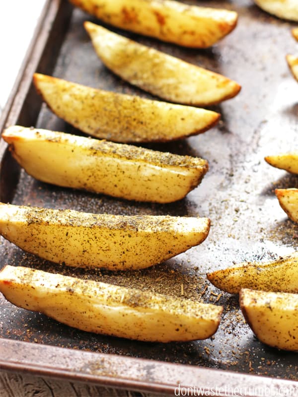 Homemade crispy potato wedges on a baking sheet pan