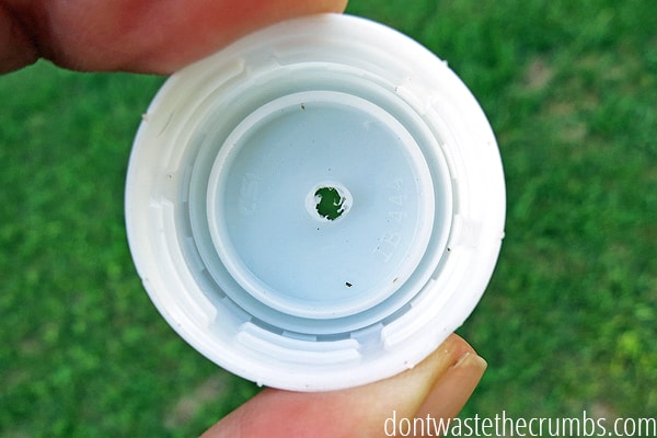 Close up view of bottle top with drilled hole in it.
