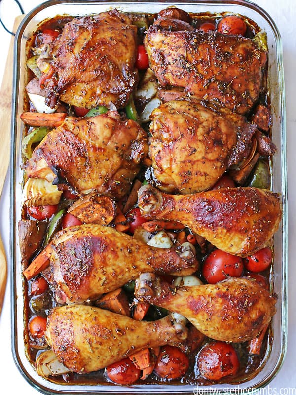 A Birdseye view of Sweet & Sticky Chicken placed above onions, tomatoes,  peppers, and carrots.