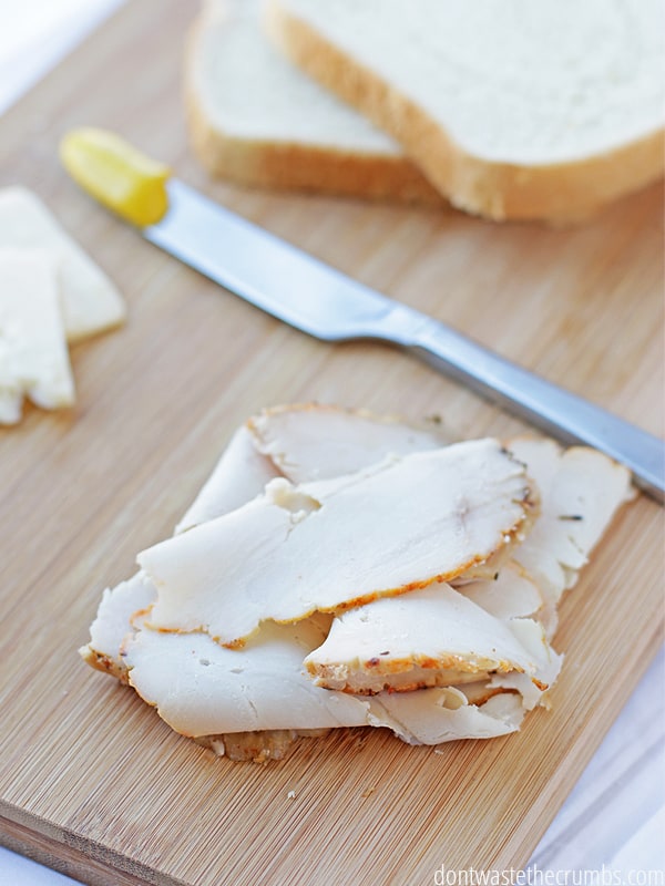 DIY lunch meat on a cutting board with a knife.