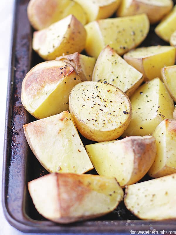 Cut potatoes on a baking sheet.