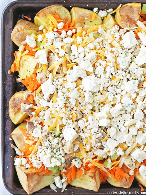 Buffalo chicken potato nachos on a baking sheet pan.