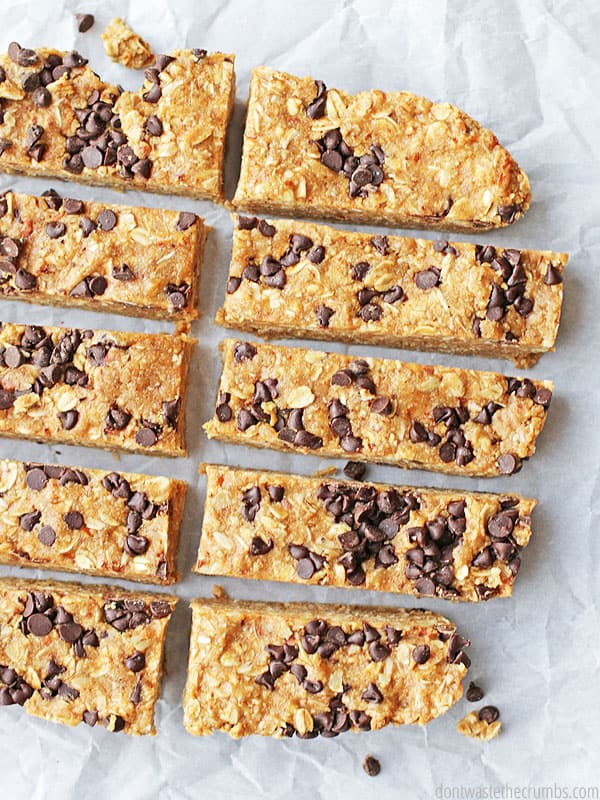 These delicious peanut butter granola bars are all cut and ready to be eaten! They are cut in rectangles and have chocolate chips in them.