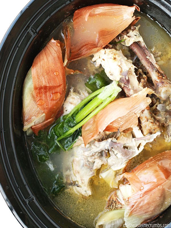 Homemade chicken stock is so easy when you start with slow cooker chicken. Costs just a few pennies, and it's packed with flavor! :: DontWastetheCrumbs.com