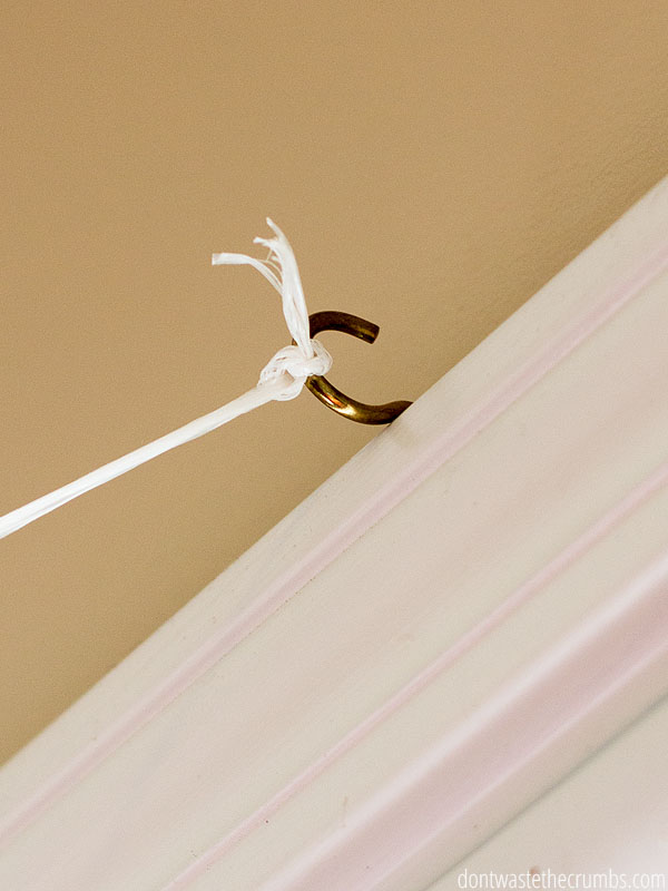 Tie your homemade clothesline indoors to a simple screw hook at the top of a doorframe.