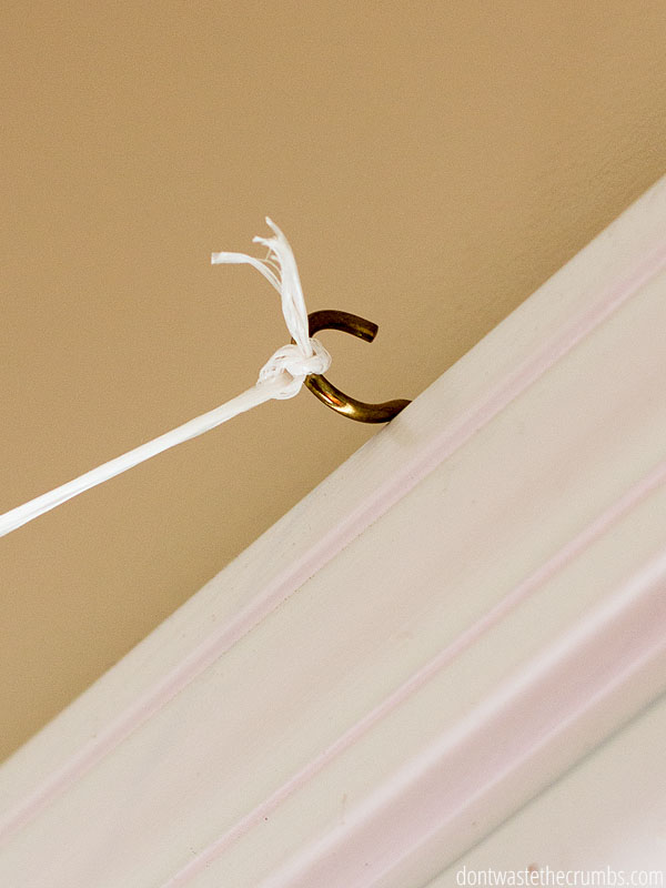 Tie your homemade clothesline indoors to a simple screw hook at the top of a doorframe. 