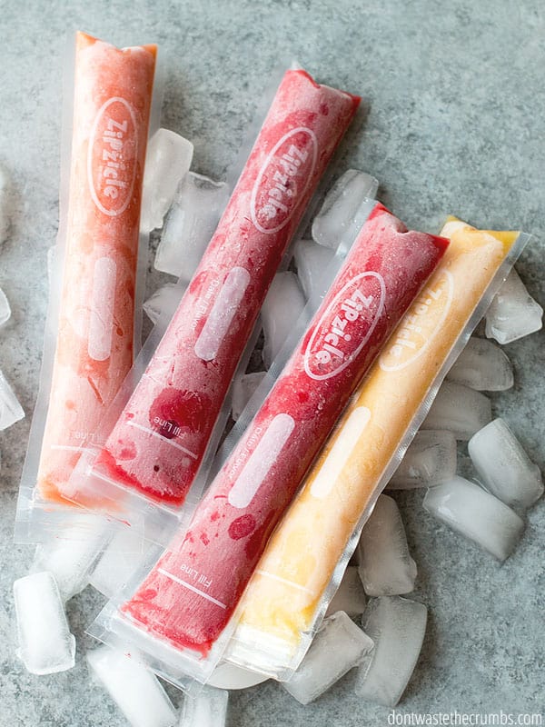 Zipzicle bags are filled with frozen fruit and juices and lay on a bed of ice.