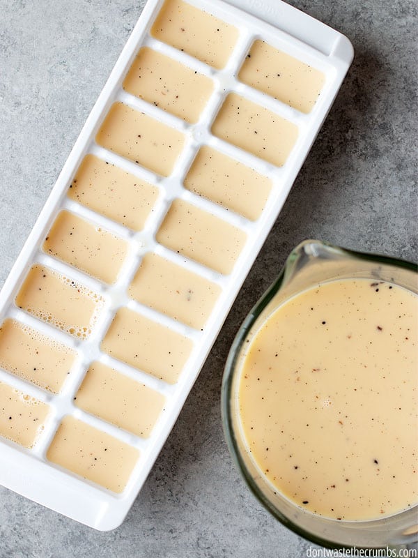 Ice cream mixture in a measuring cup and the mixture has been poured into an ice cube tray.