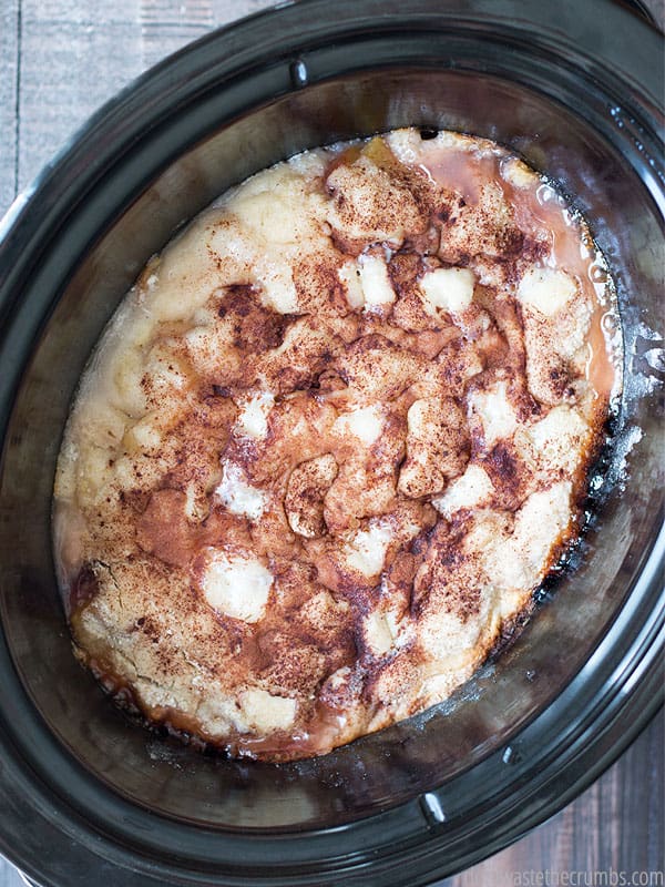When you don't know what to take to a pot-luck, make this slow cooker peach cobbler. It's so easy to make with fresh or canned peaches, and you already have everything else in the pantry! :: DontWastetheCrumbs.com