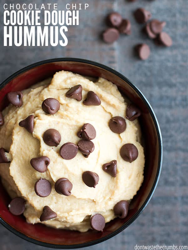 Bowl of cookie dough hummus topped with chocolate chips with text overlay, "Chocolate Chip Cookie Dough Hummus".