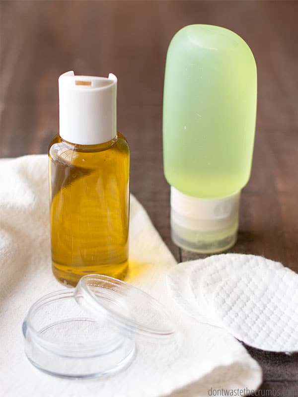 Small bottle of makeup remover, small squeeze bottle, small container, and cotton pads