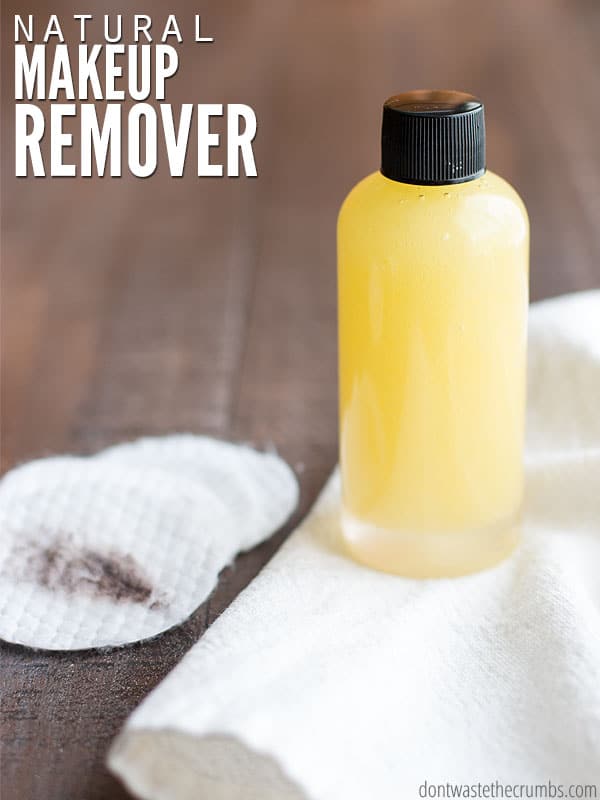Bottle of homemade makeup remover with cotton pads on a table with text overlay, "Natural Makeup Remover".