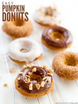 Assorted homemade light and fluffy pumpkin spice donuts, with various toppings. Text overlay Easy Pumpkin Donuts.