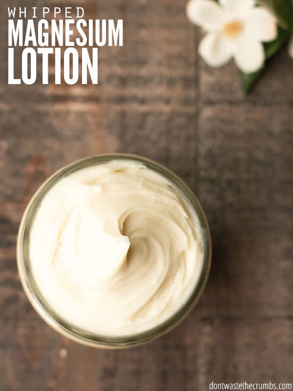 Magnesium lotion in a jar on a table with text overlay, "Whipped Magnesium Lotion".