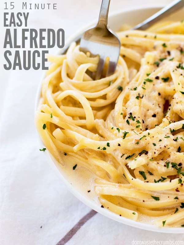 Plate of fettuccine alfredo and a fork twirling the noodles. Text overlay reads "15 Minute Easy Alfredo Sauce"