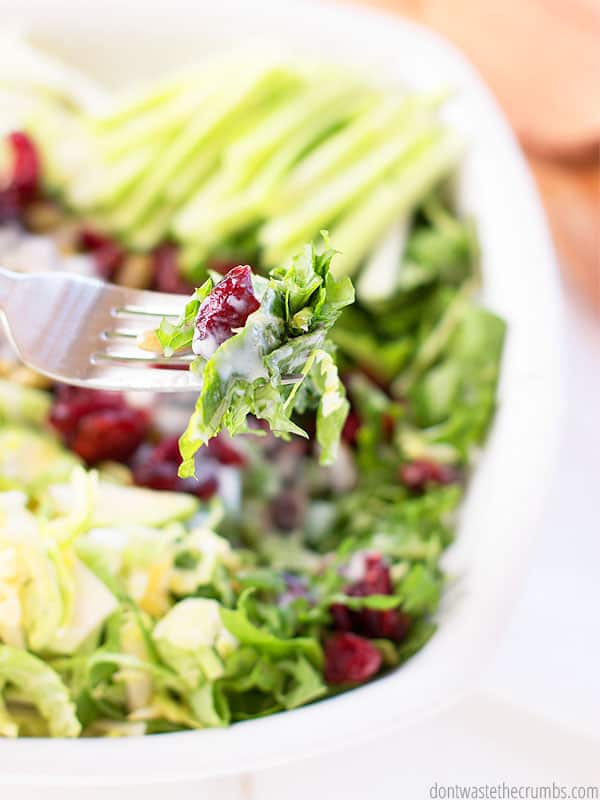 This sweet kale salad recipe is ready! There is a fork with a bite size on it.