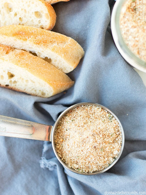 Slices of bread and a measuring cups of homemade breadcrumbs