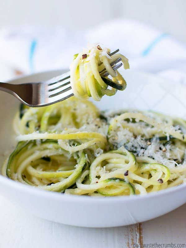 Close up of a fork with zucchini noodles twirled around it.