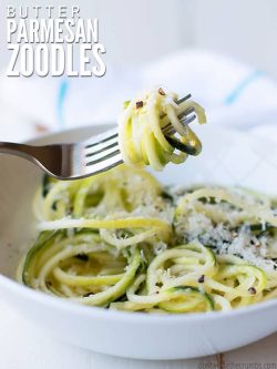 Bowl of zucchini noodles topped with Parmesan cheese and a fork with zoodles wrapped around it with text overlay, "Butter Parmesan Zoodles".
