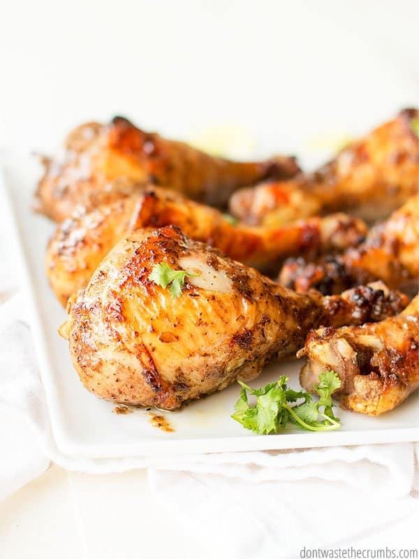 This Jamaican jerk chicken recipe is one to try! Pictured are 6 jerk chickens on a white plate.