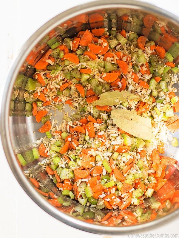 The raw seasonings and vegetables in the pot getting ready to be cooked.