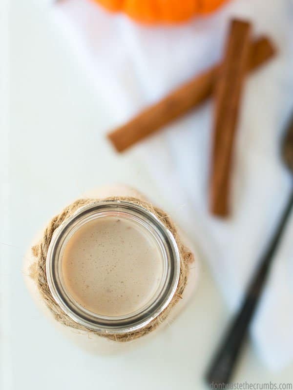 This homemade pumpkin spice coffee creamer is in a glass container ready to be used. Showing a top view. This is a must try for the holidays and mornings all year round!