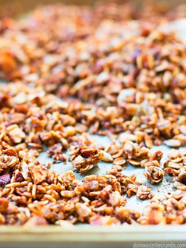 Up close view of this easy cinnamon granola recipe on a baking sheet.