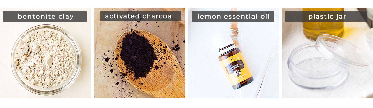 Image containing recipe ingredients bentonite clay, activated charcoal powder, lemon essential oil, and plastic storage jar.