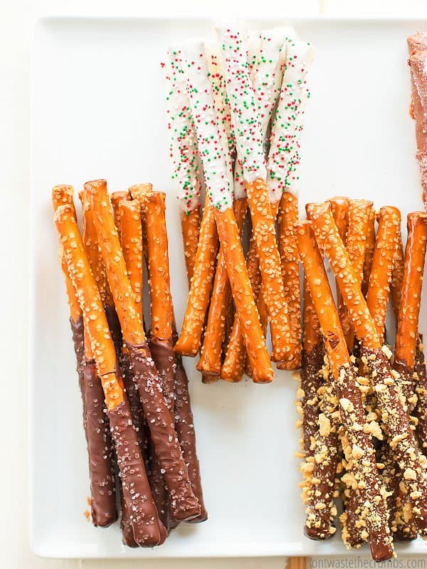 Chocolate covered pretzels 3 ways with white, milk and dark chocolate. Topped with holiday sprinkles, sea salt and nuts. 