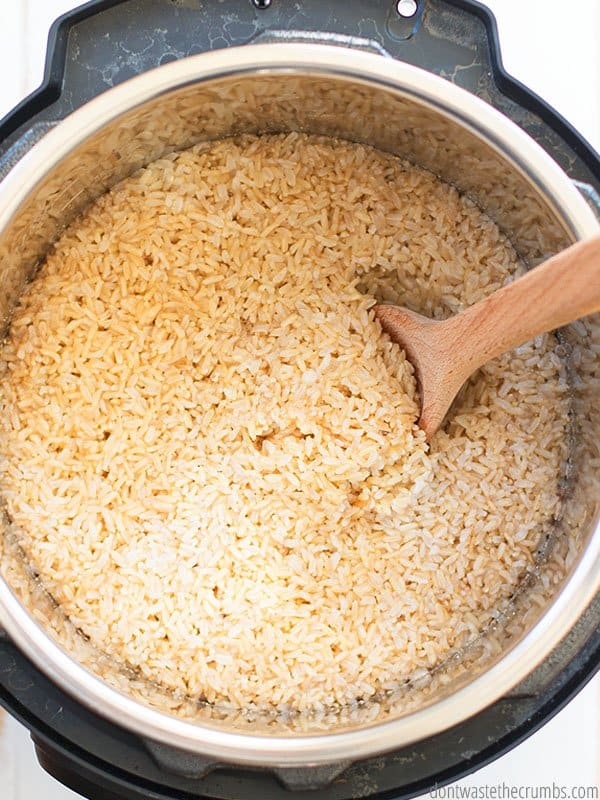 This Instant Pot Brown rice is ready! There is a wooden spoon inside the pot to stir and fluff the rice.