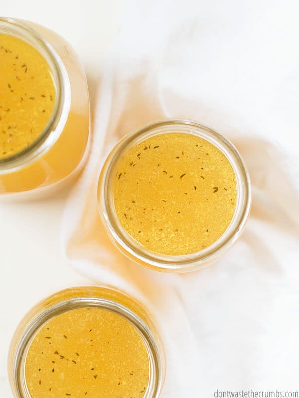These jars of brightly colored instant pot chicken broth are cooling with the lids off.