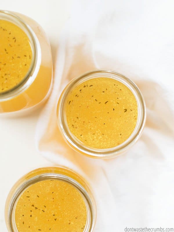 Make a full batch of chicken stock in less than an hour using chicken bones and vegetable scraps. Mason jars, like the ones shown in the picture, are great for storage.