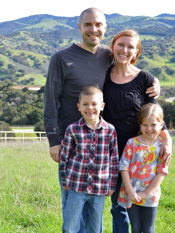 A photo of Mr. and Mrs. Crumbs with their two little ones in 2014, in front of a scenic mountain backdrop.