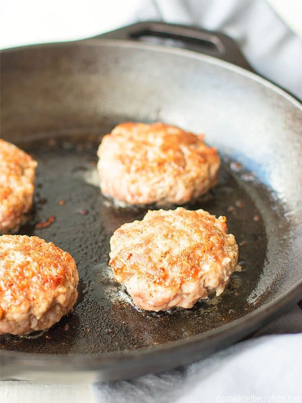 Sausage cooking in a cast iron skillet