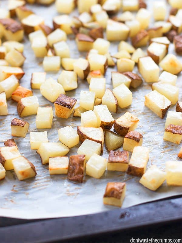 Oven roasted hash browns on a parchment lined baking sheet pan