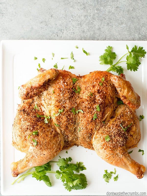 The Whole30 on a budget IS possible! I've learned a few tricks with my family that can help you achieve a Whole30 too. An entire chicken with herbs on a white platter.