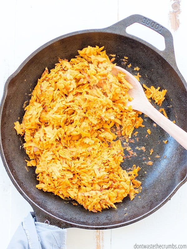 Sweet potatoes are heating up in coconut oil on the cast iron skillet.