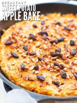 Cast iron skillet filled with golden brown, shredded back potatoes, topped with raisins and pecans. Text overlay Breakfast Sweet Potato Apple Bake.