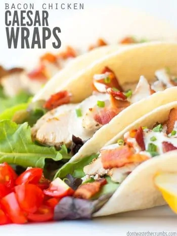 Two flour tortillas wraps overflowing with sliced chicken, bacon bits, leaf lettuce, diced tomatoes, all dressed ranch dressing. Text overlay Bacon Chicken Caesar Wraps..
