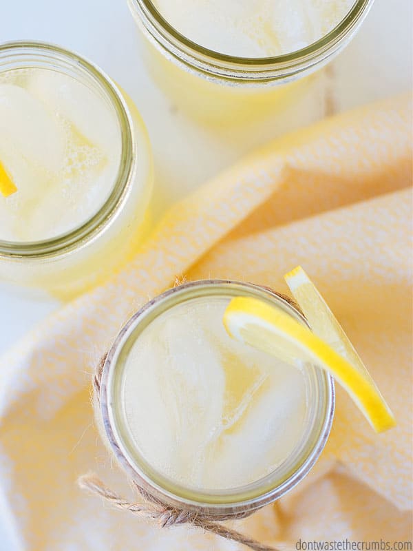 Birds eye view of homemade lemonade in a mason jar with a lemon wedge on the rim