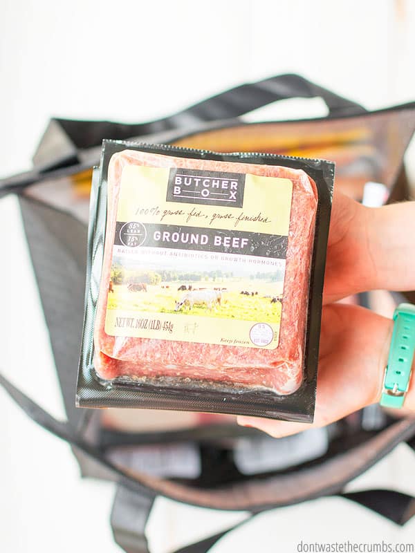 Hands holding Butcher Box ground beef in its package